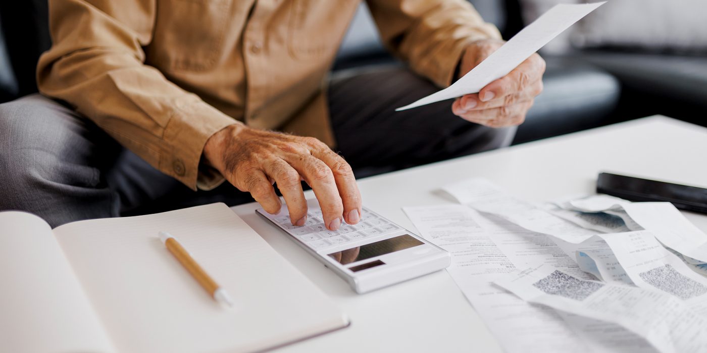 senior man calculating assisted living tax deductions